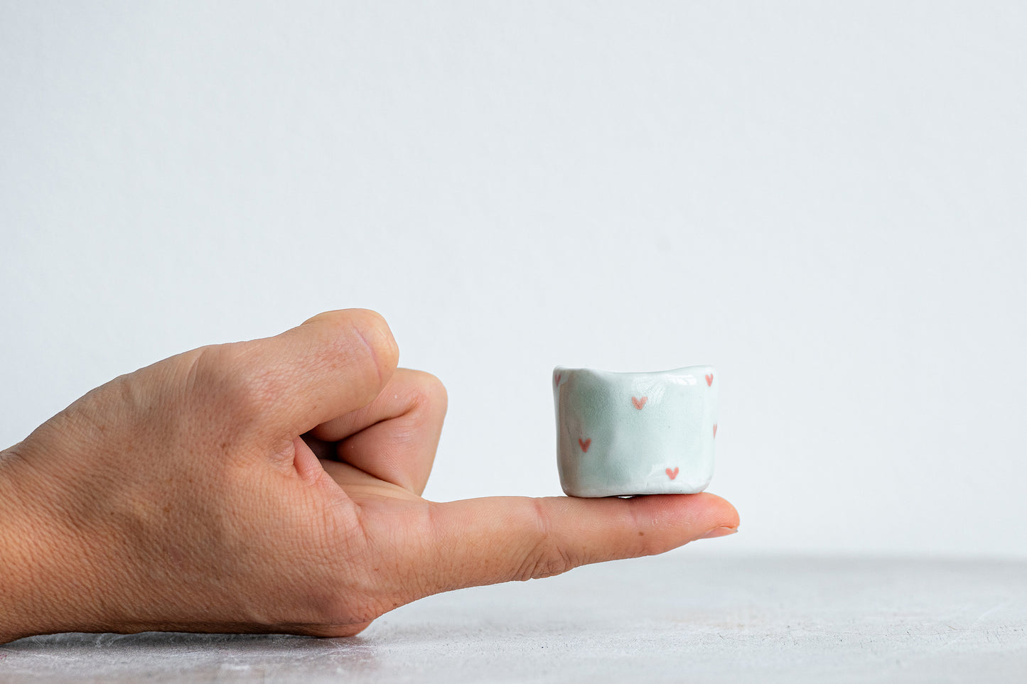 tiny porcelain pinch pot vessels with a hand painted heart design
