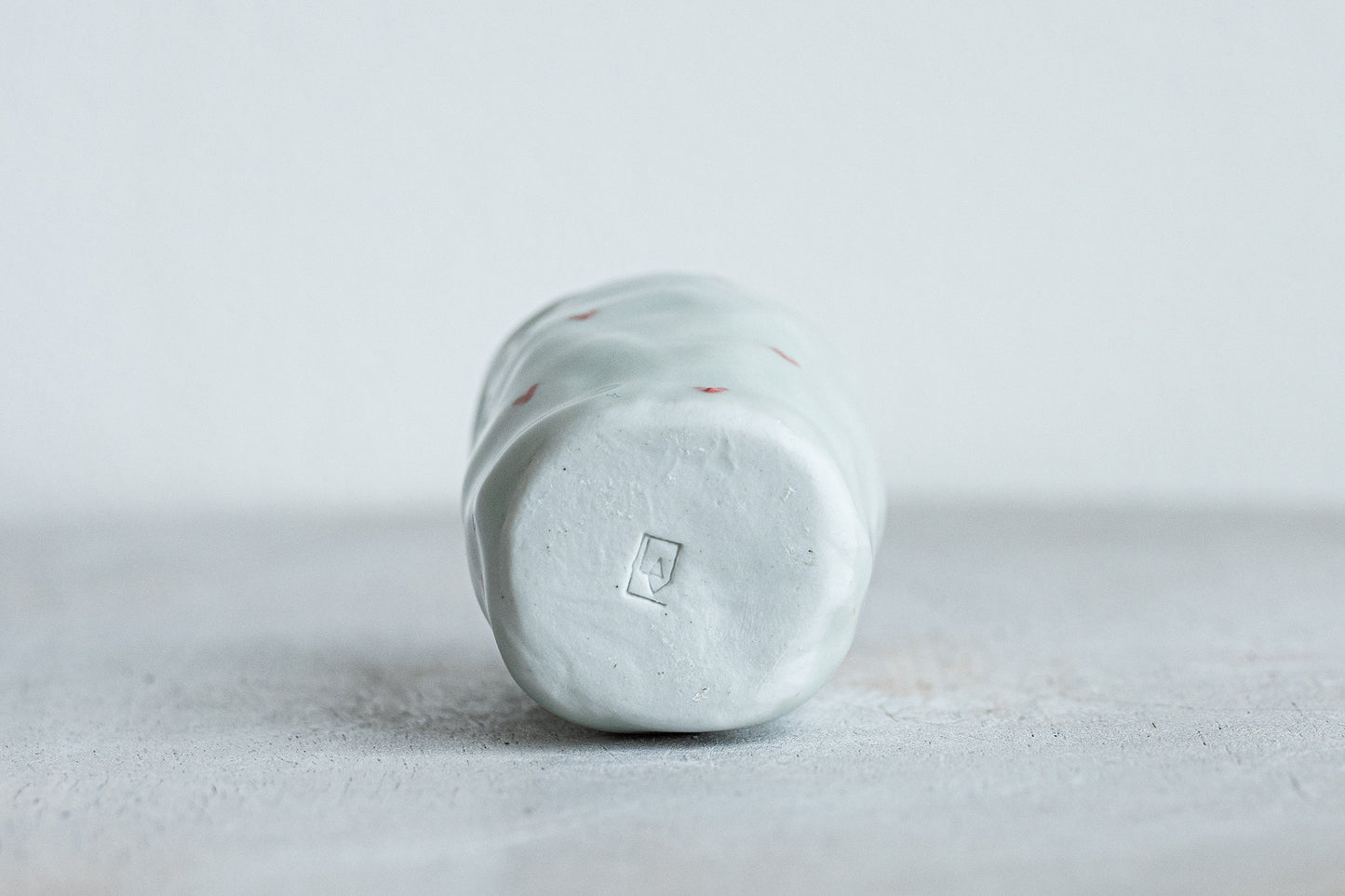 tiny porcelain pinch pot vessel with a hand painted heart design underdog