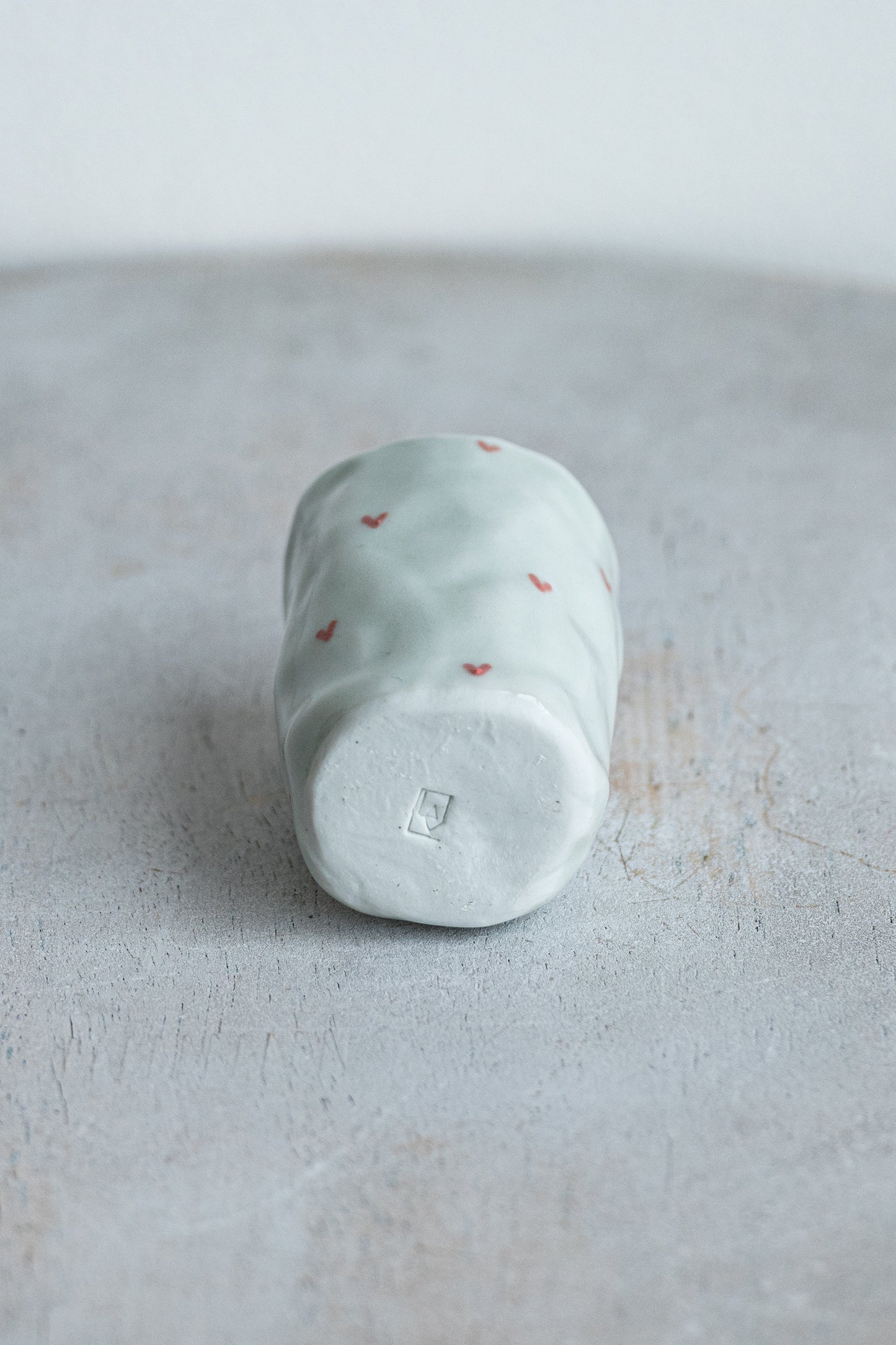 tiny porcelain pinch pot vessel with a hand painted heart design underdog