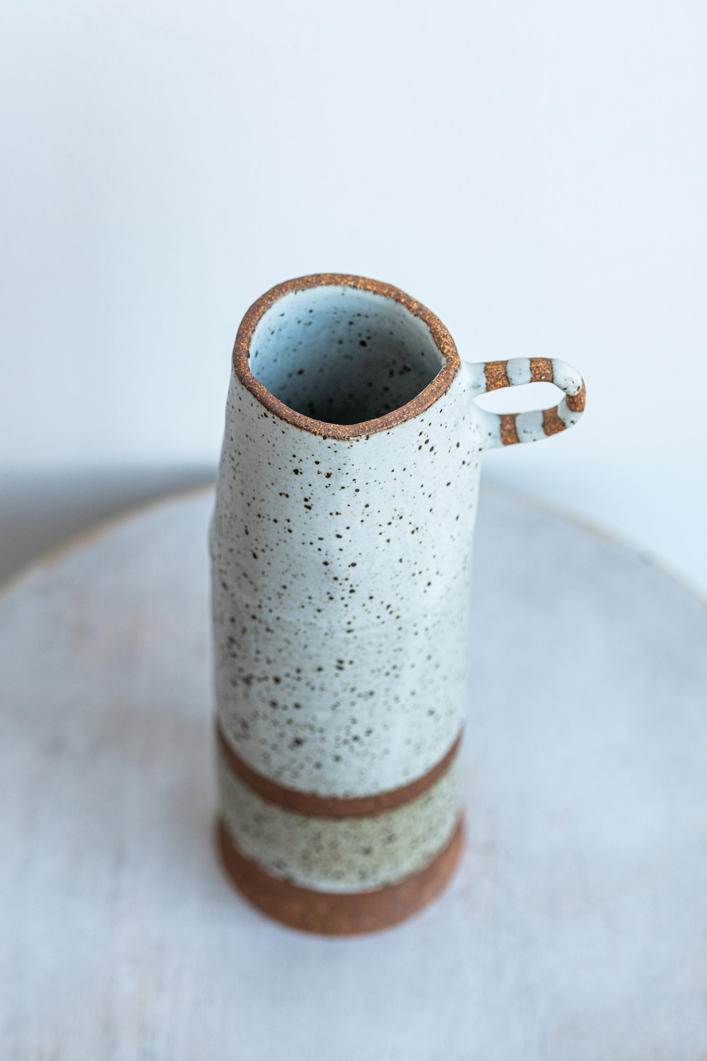 underdog tall stoneware vase with striped handle