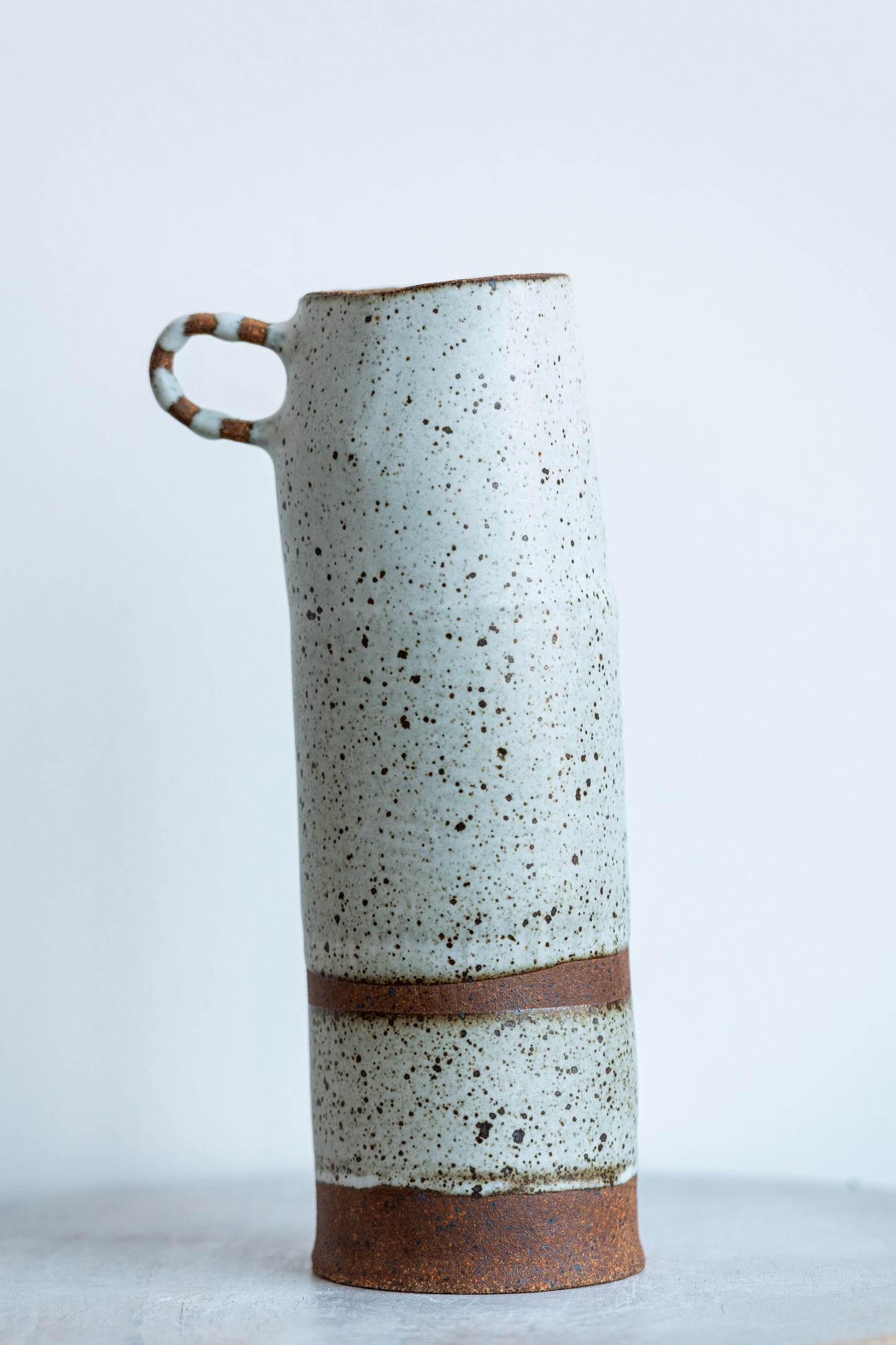 underdog tall stoneware vase with striped handle