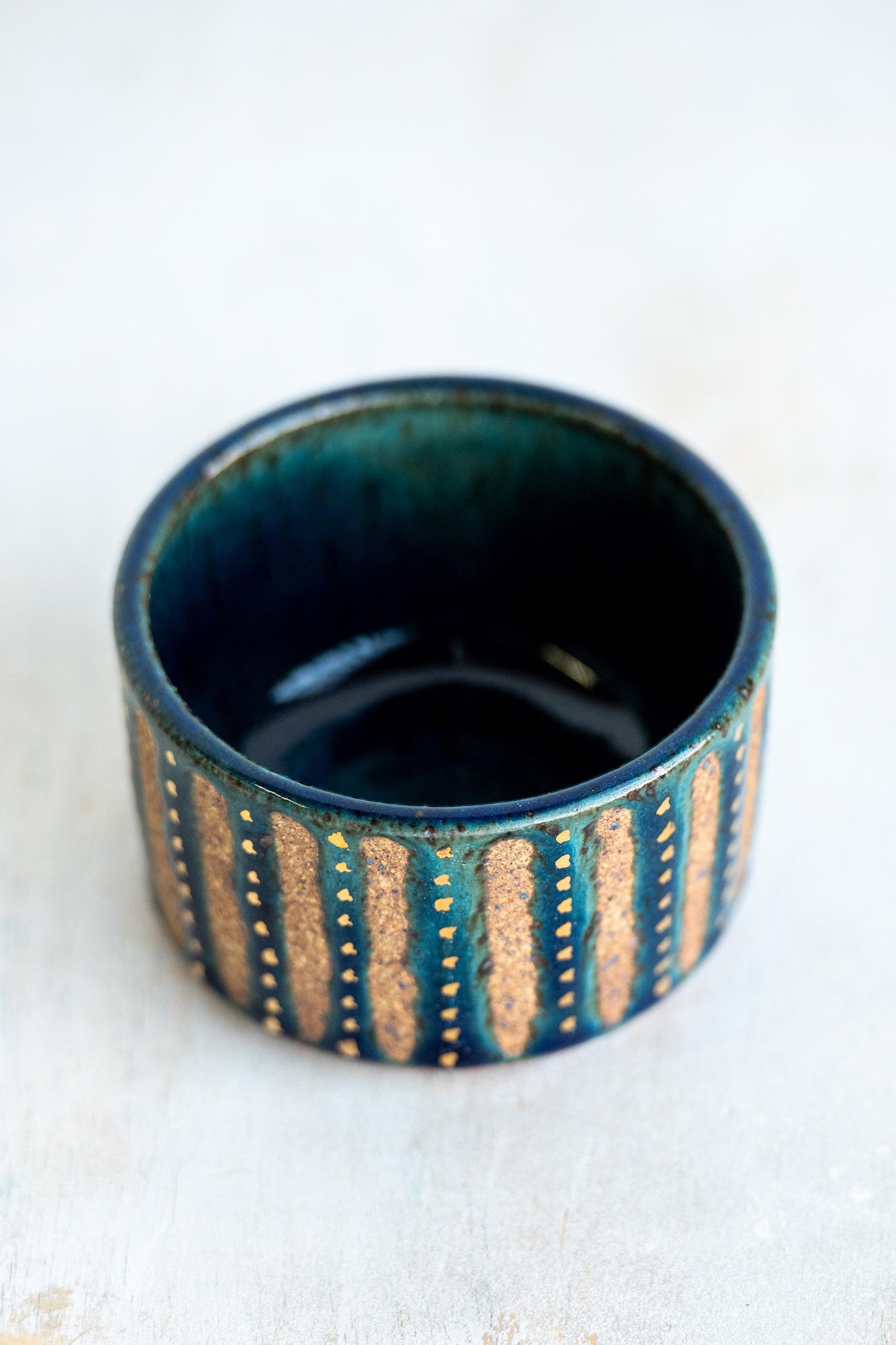 gold speckled blue stoneware vessel