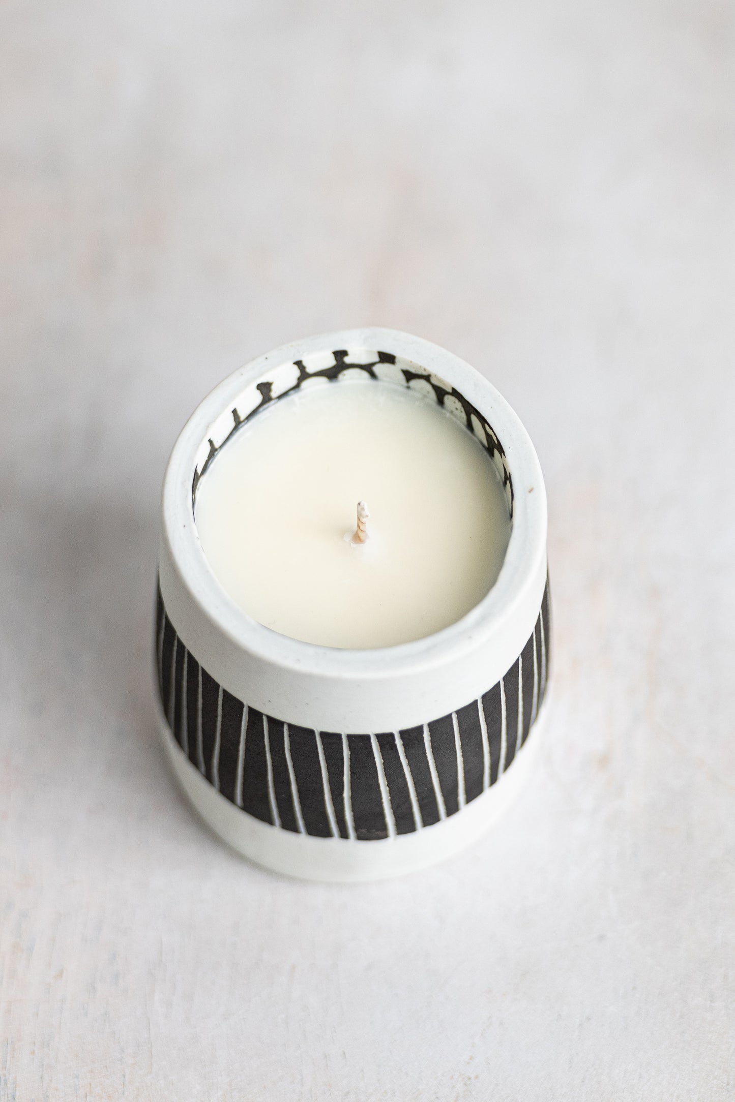 black striped exterior with white blocked interior underdog porcelain candle