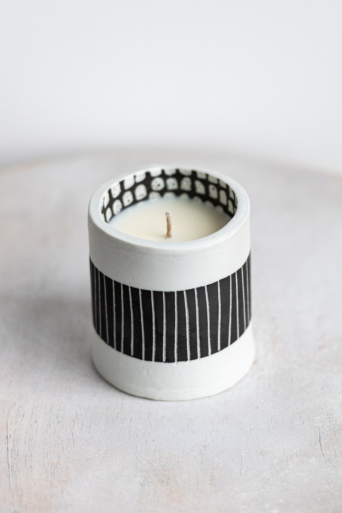 black striped exterior with white blocked interior underdog porcelain candle