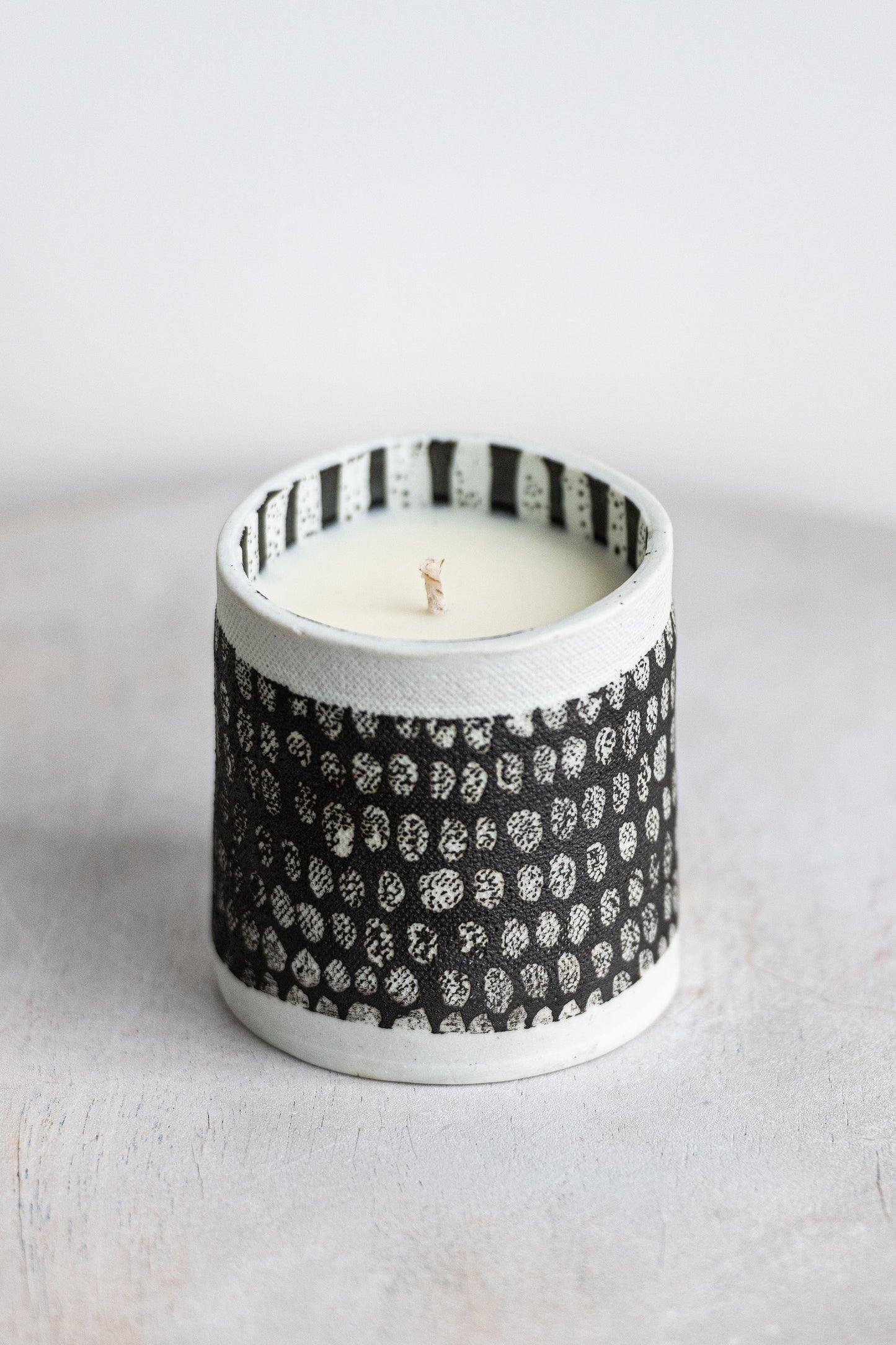white blocked exterior with black striped interior underdog porcelain candle