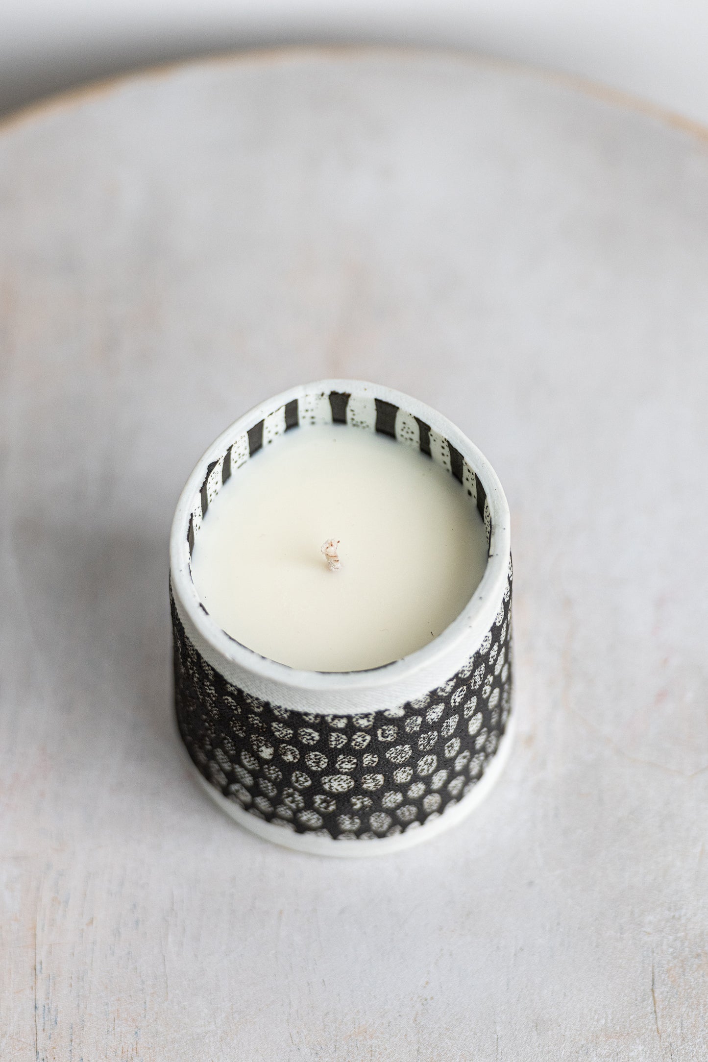 white blocked exterior with black striped interior underdog porcelain candle