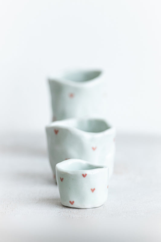 tiny porcelain pinch pot vessels with a hand painted heart design
