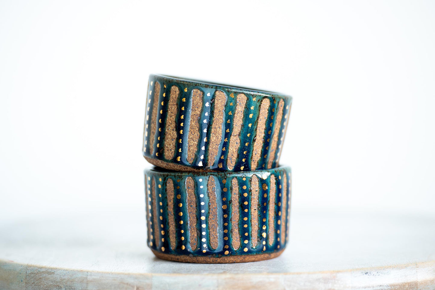 gold speckled blue stoneware vessel